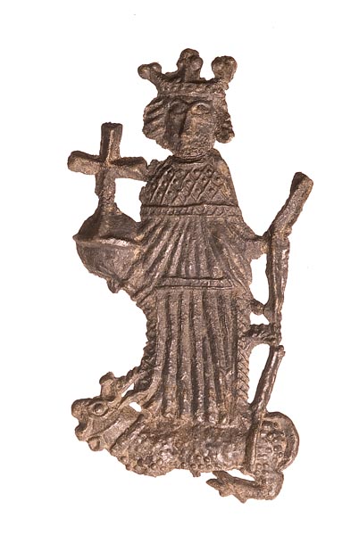Pewter badge of King Henry VI. He wears robes of state and holds an orb in his right hand and a sceptre in his left. An antelope with a forked tail and serrated horns lies at his feet.
