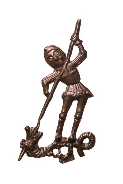 Pewter pilgrim badge of St George. He wears full armour and stands over a dragon, driving a spear into its mouth. On his chest is a cross.