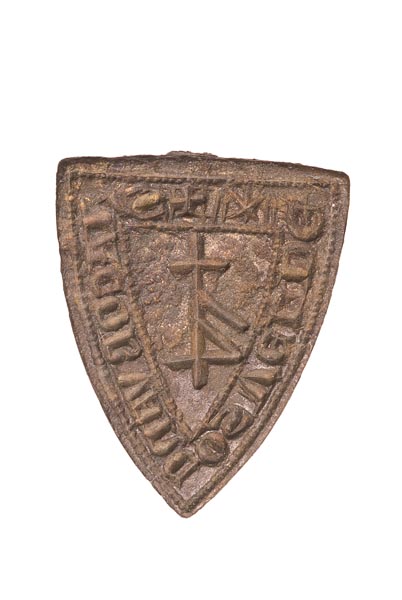 Copper alloy seal matrix in the shape of a shield. In the centre is a merchant's mark or symbol and around the edge is an inscription: 'S IACOB VAN COSVELDE' (seal of Jacob van Cosvelde).
