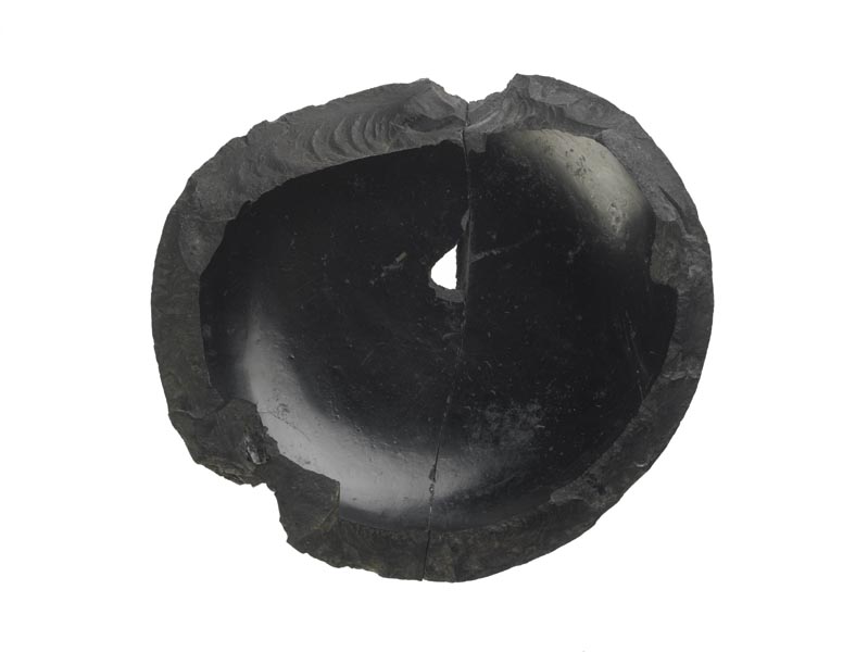 Base of a black bowl made from jet. The sides are broken.