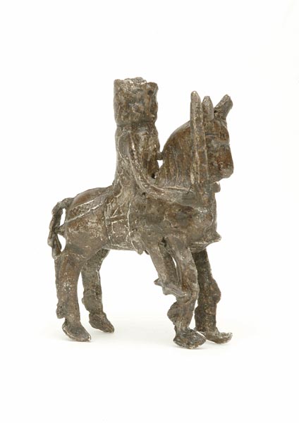 3-dimensional pewter toy of a knight on horseback. In his right hand he holds up a sword.