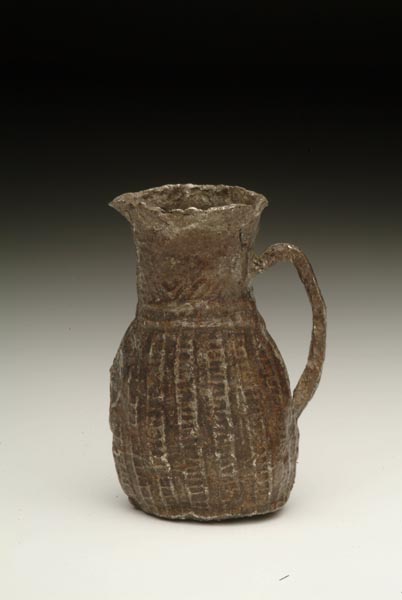 Miniature pewter jug, decorated with moulded vertical stripes down the body.