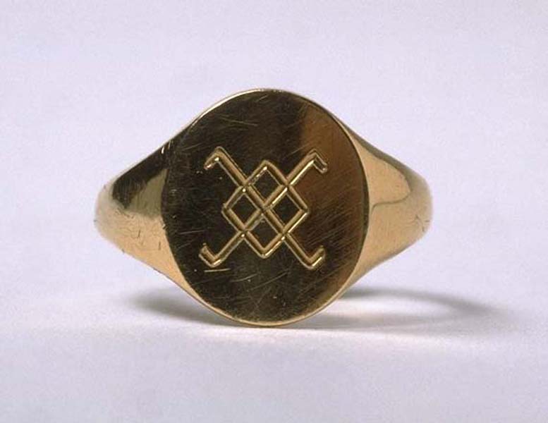 Gold ring with incised geometric design.