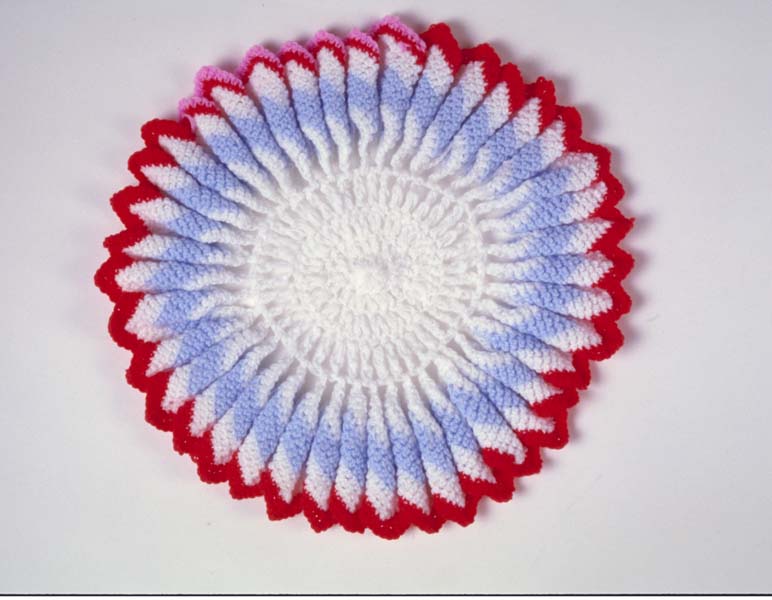 White, blue and red crocheted circle.