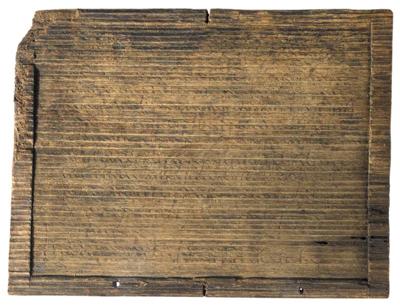 Rectangular wooden tablet surrounded with a frame.  Writing is visible on the surface.