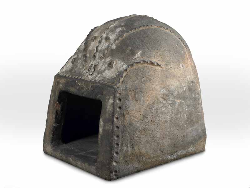 Photograph: domed oven with square opening at the front, decorated with thumbed circles and bands.