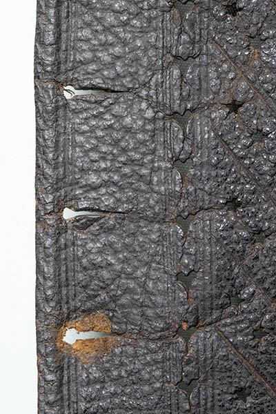 Leather jerkin (a short-sleeved jacket) decorated with slashes and holes cut through the leather.